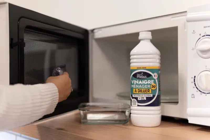 Image d'une bouteille de vinaigre ménager 20° Phebus devant un micro-ondes